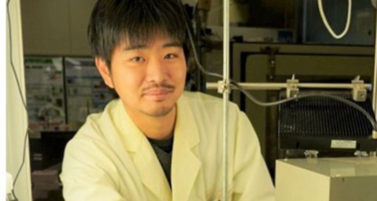 Yuta Miyoshi posing for the camera in a lab