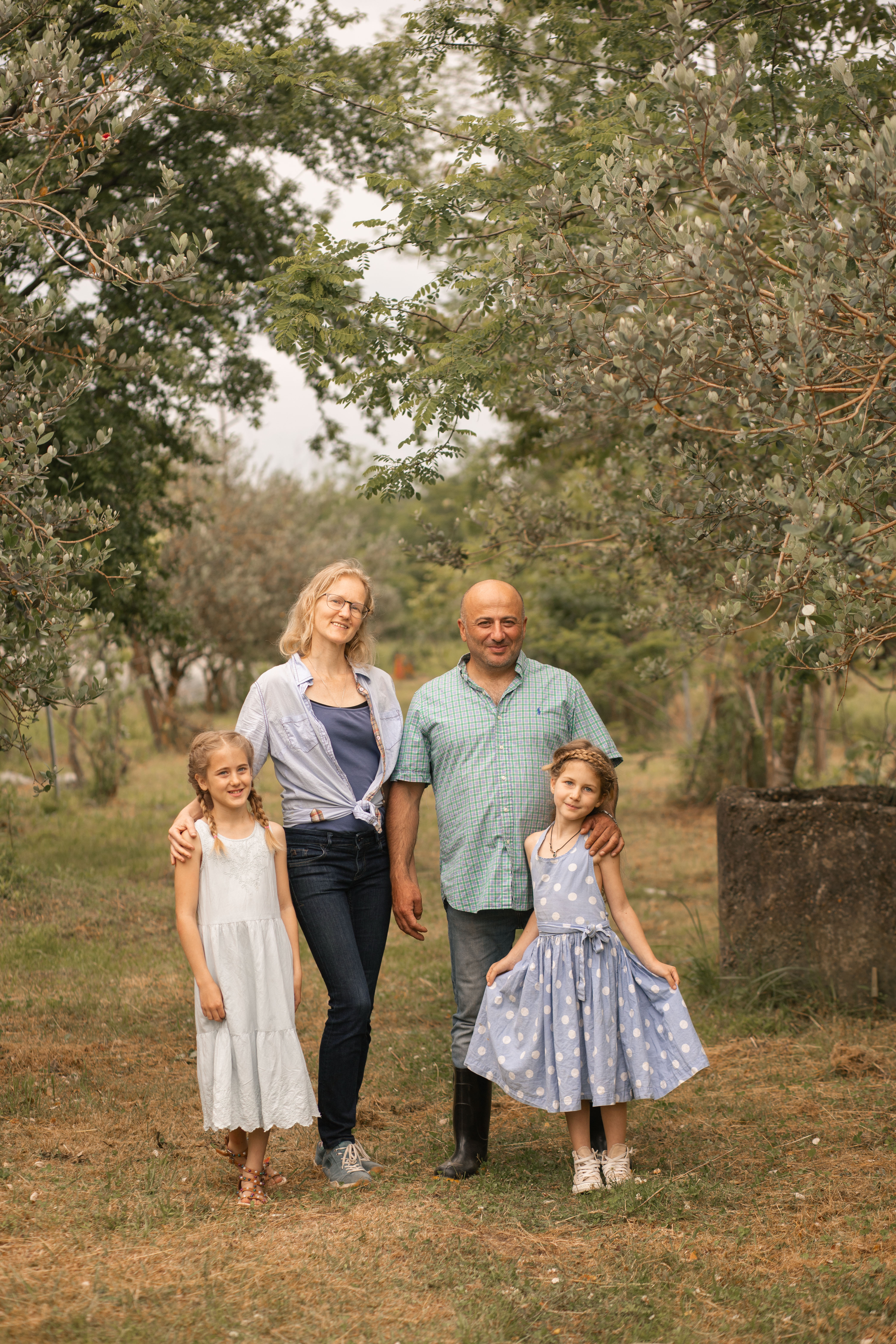 Anna samwel with her husband and two kids posing for the camera in the ecofarm