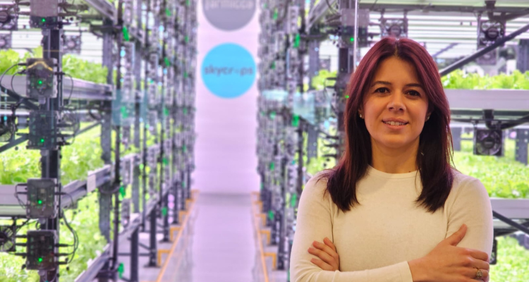 Gamze posing in front of a vertical farming system