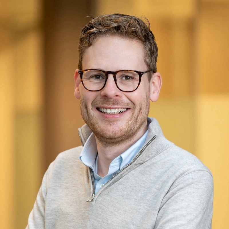 potrait picture of smiling man with glasses
