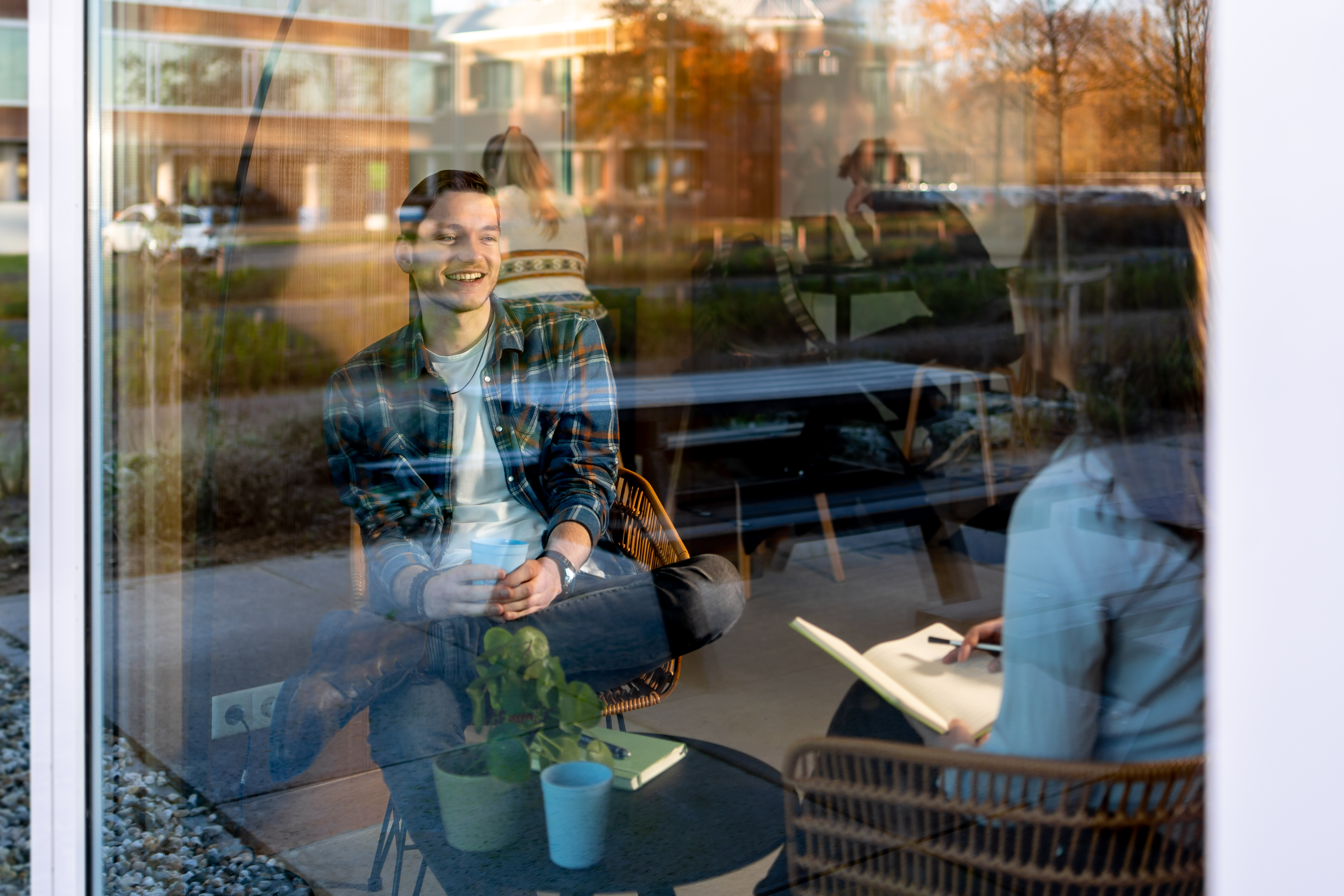 Man sits behind window