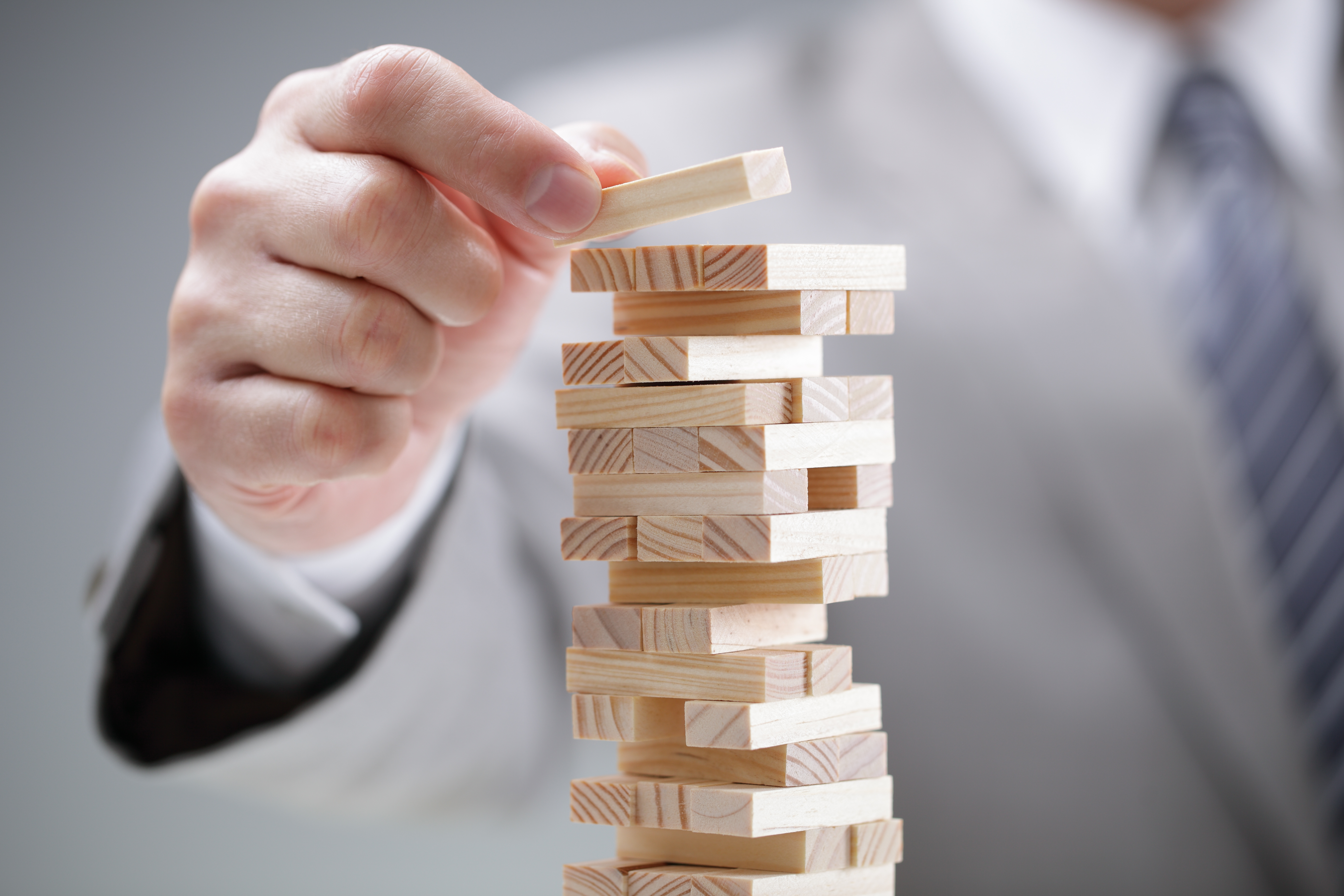 Man in suit playing jenga