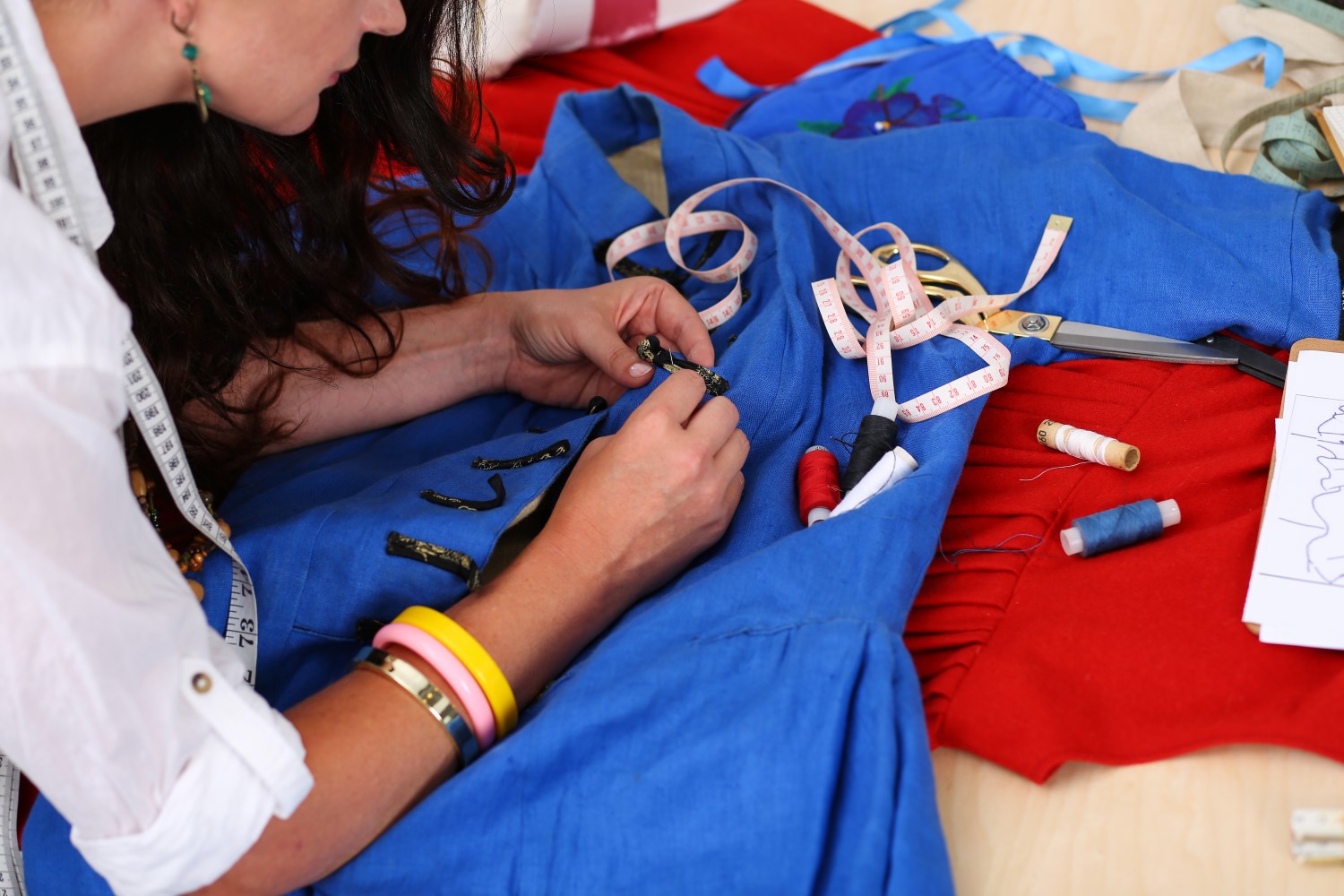 female fashion designer sewing fabric