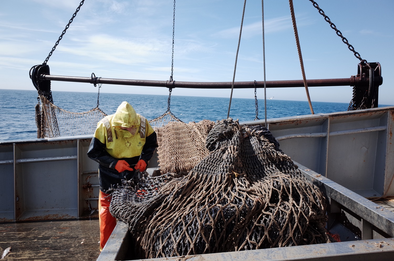 Man with fishing nets on fishing boat
