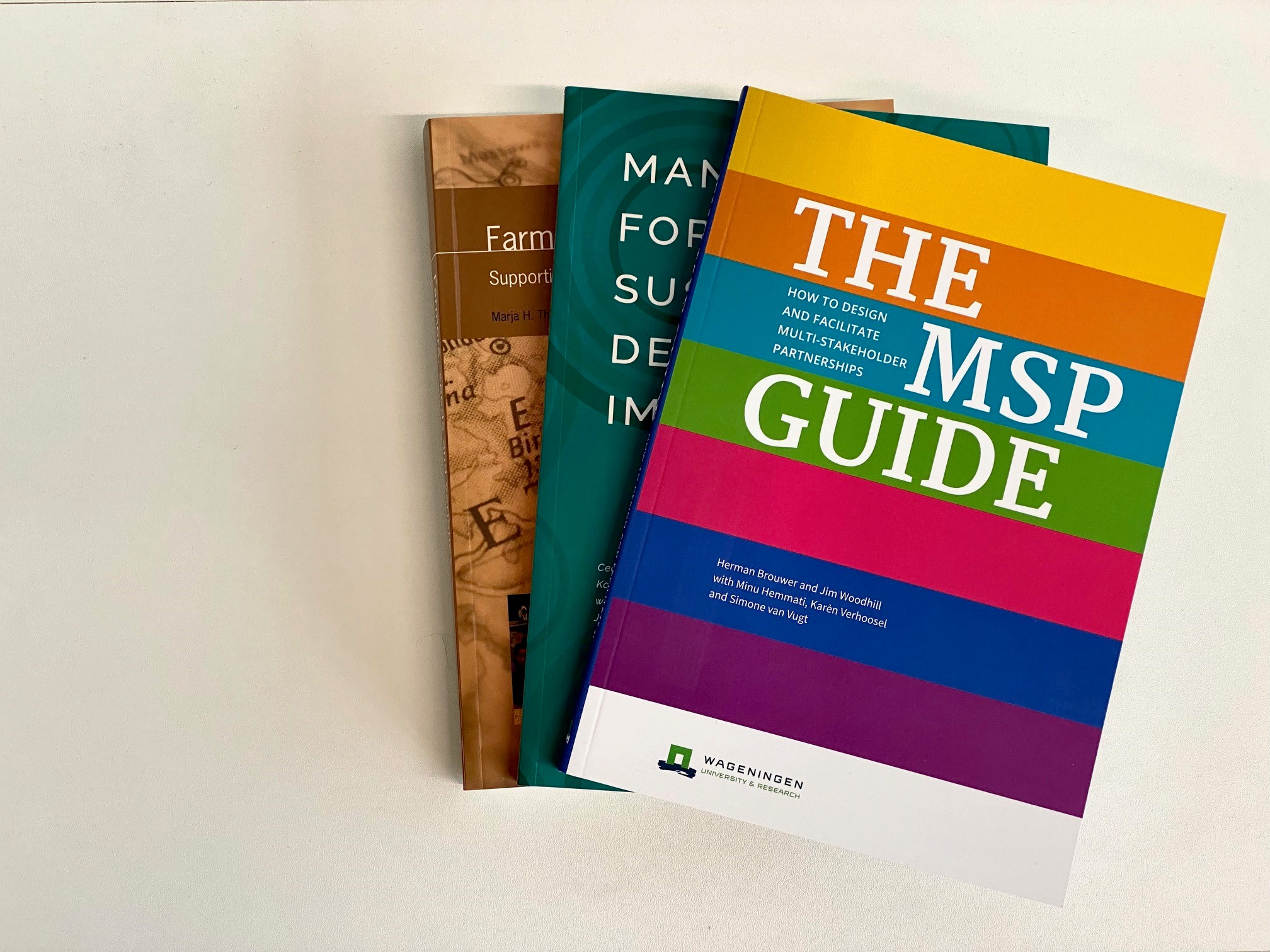 Pile of paper guide books, on top is the MSP guide.