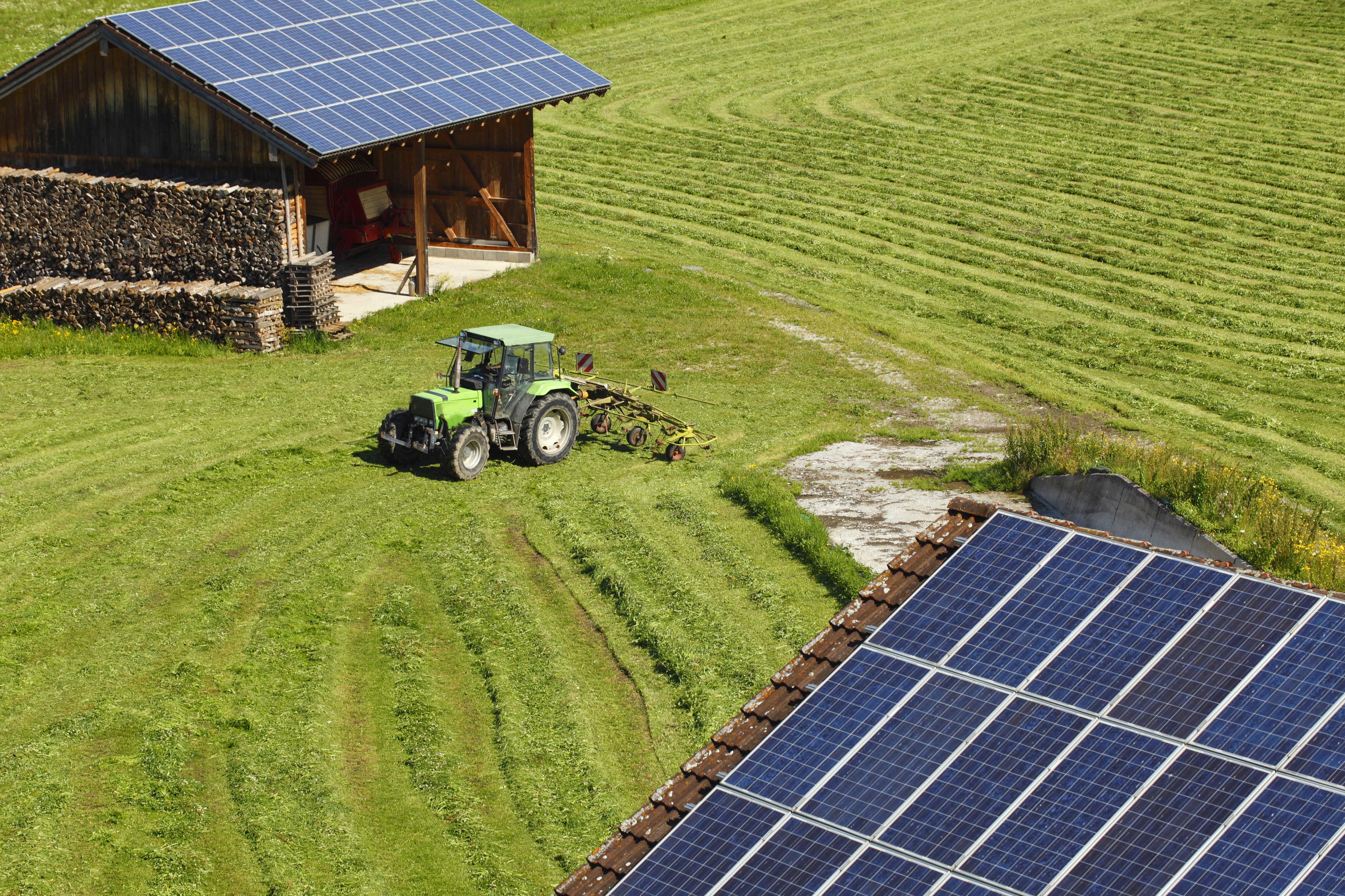 Solar panel on a farm with tractor and shed