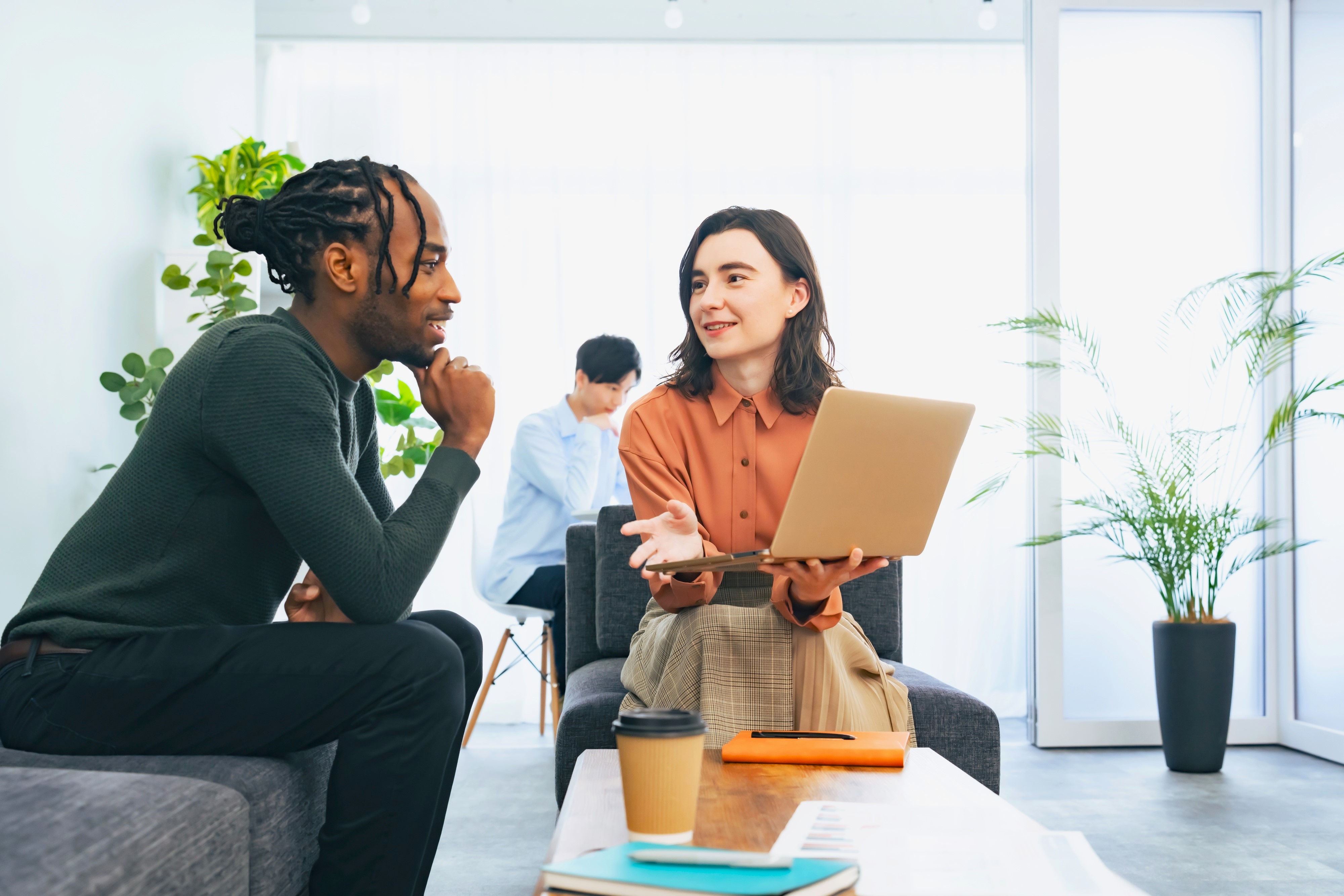 Two people with a laptop discussing a project