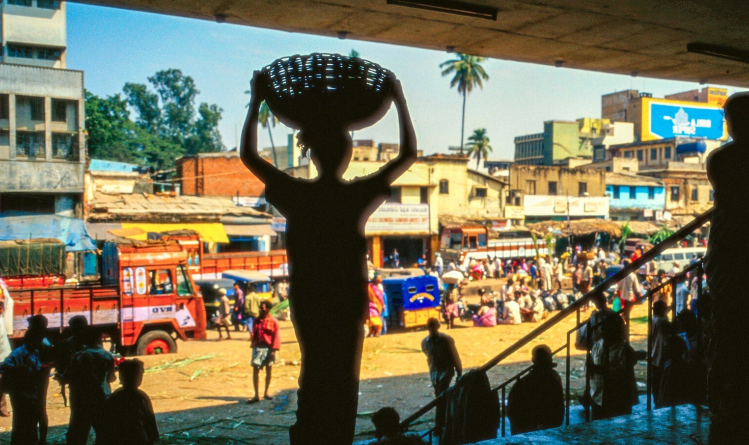 Food seller looks out on a road in India.