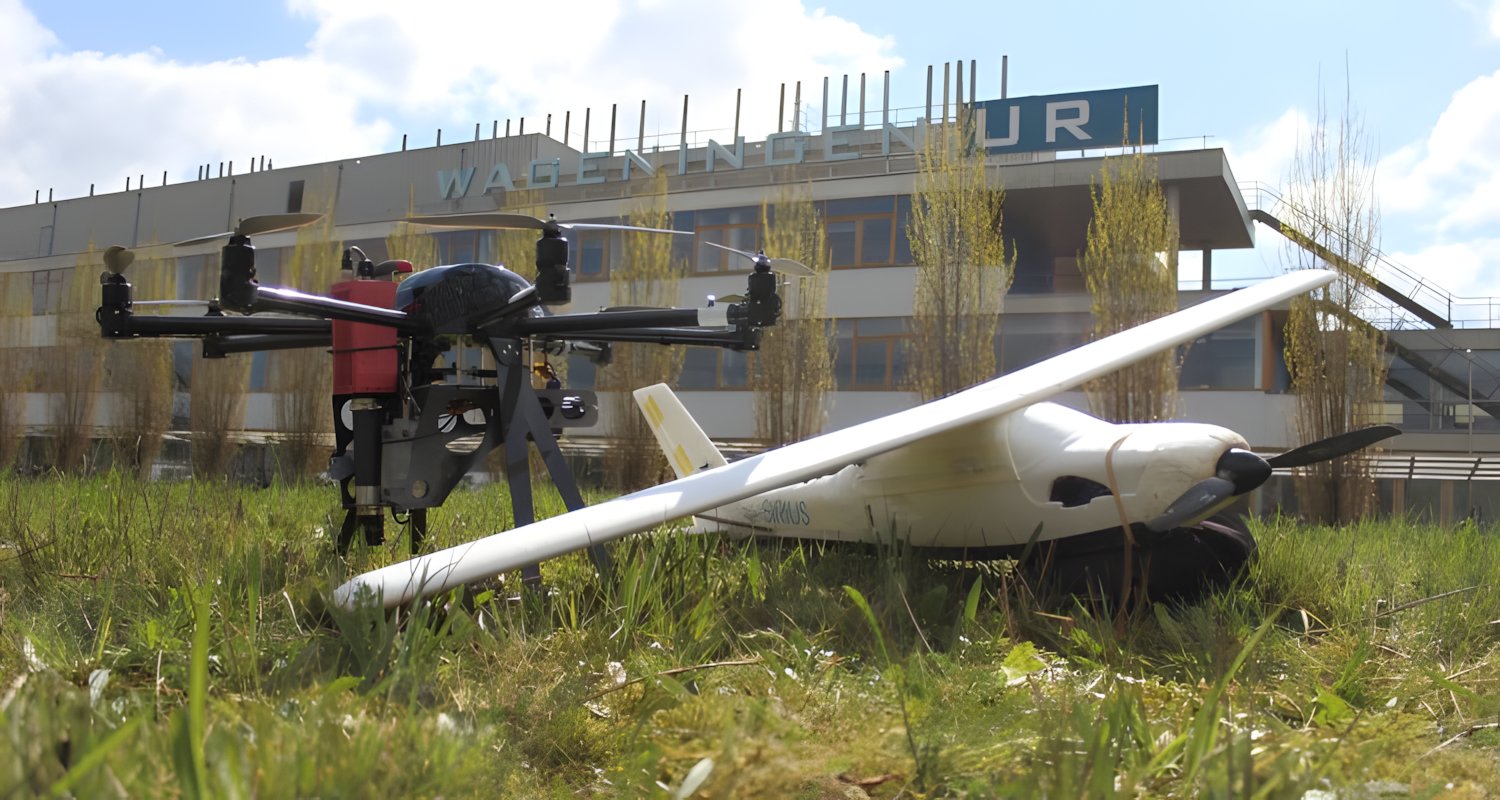 Drone and mini plane laying in the grass in front of a WUR building