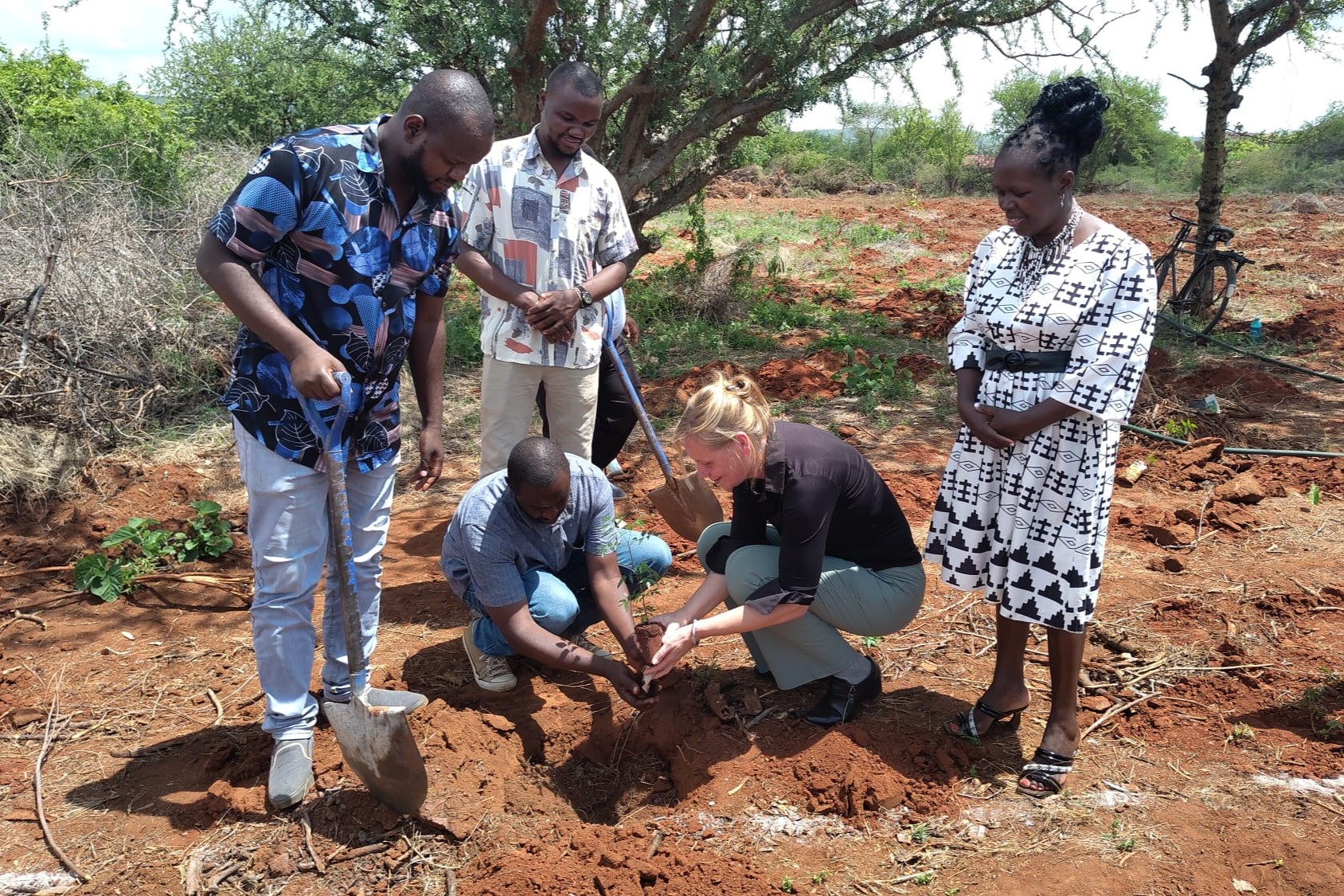 Mirjam and Lukenya staff plant the first trees of the Wageningen University Forest in Kenya.
