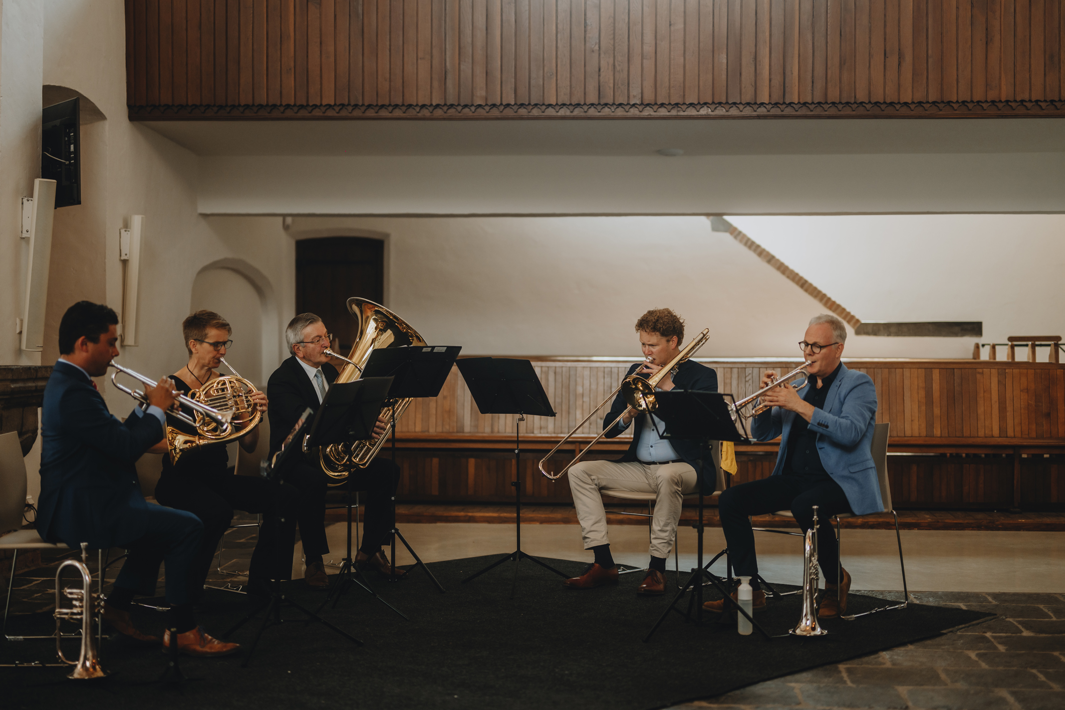 Brass quintet playing their instruments