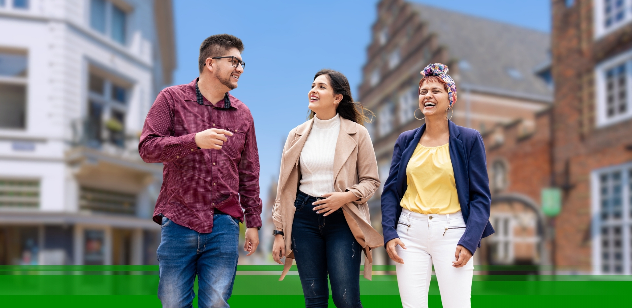 Three people walking down a Dutch street, laughing and chatting