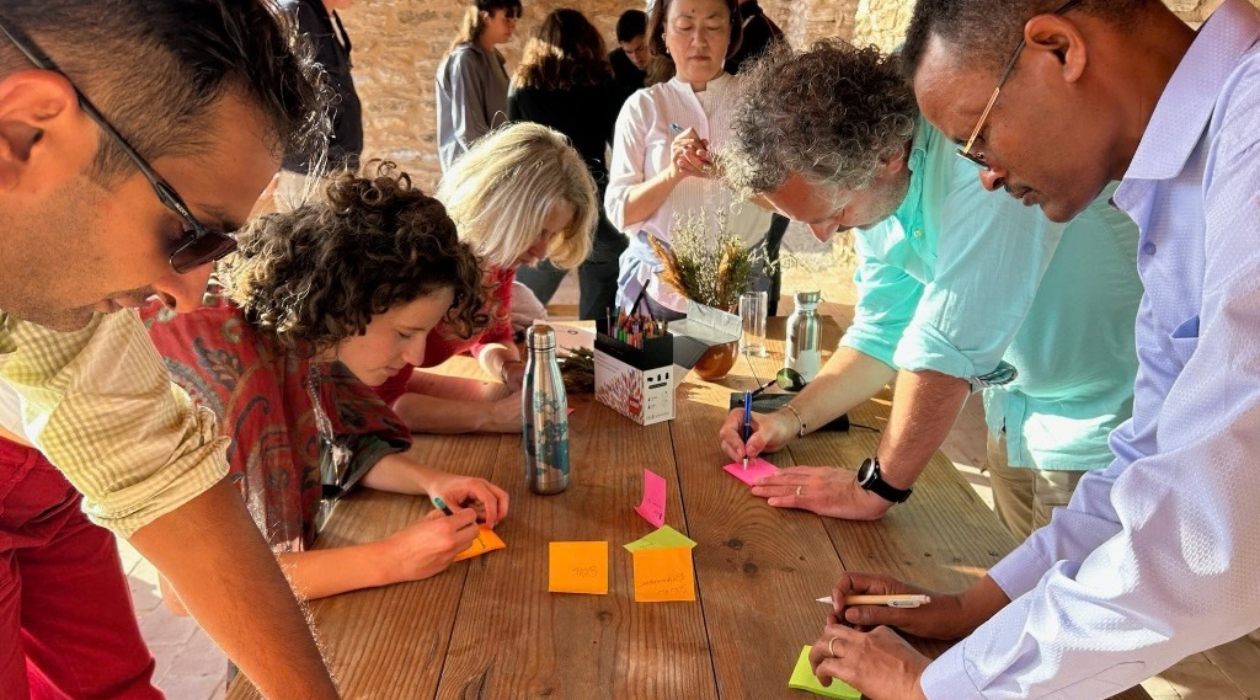 people around a table with post it notes