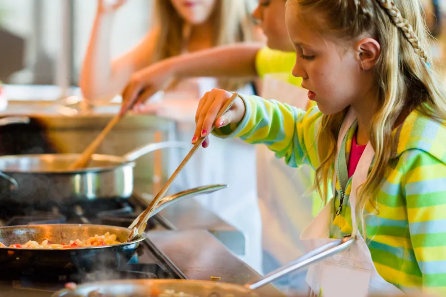 Children learning to cook.